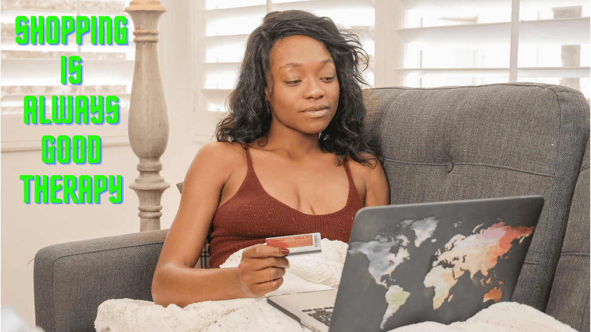 Photo of young black women holding a credit card and staring at a laptop